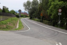 zakręt na drodze asfaltowej, z poboczem  i pasem zieleni w Stojowicach